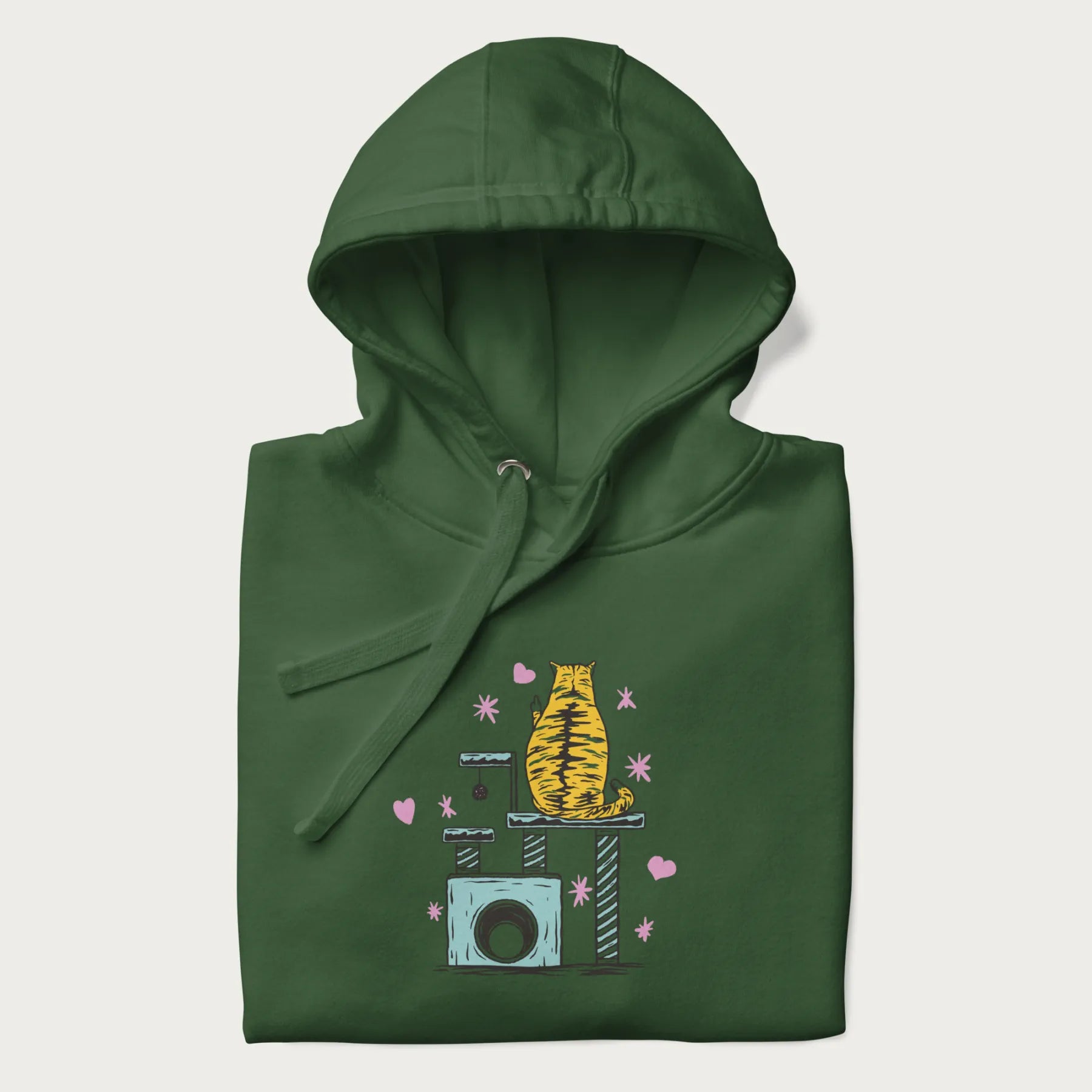 Folded forest green hoodie with graphic of a tabby cat on a scratching post, raising its middle finger.