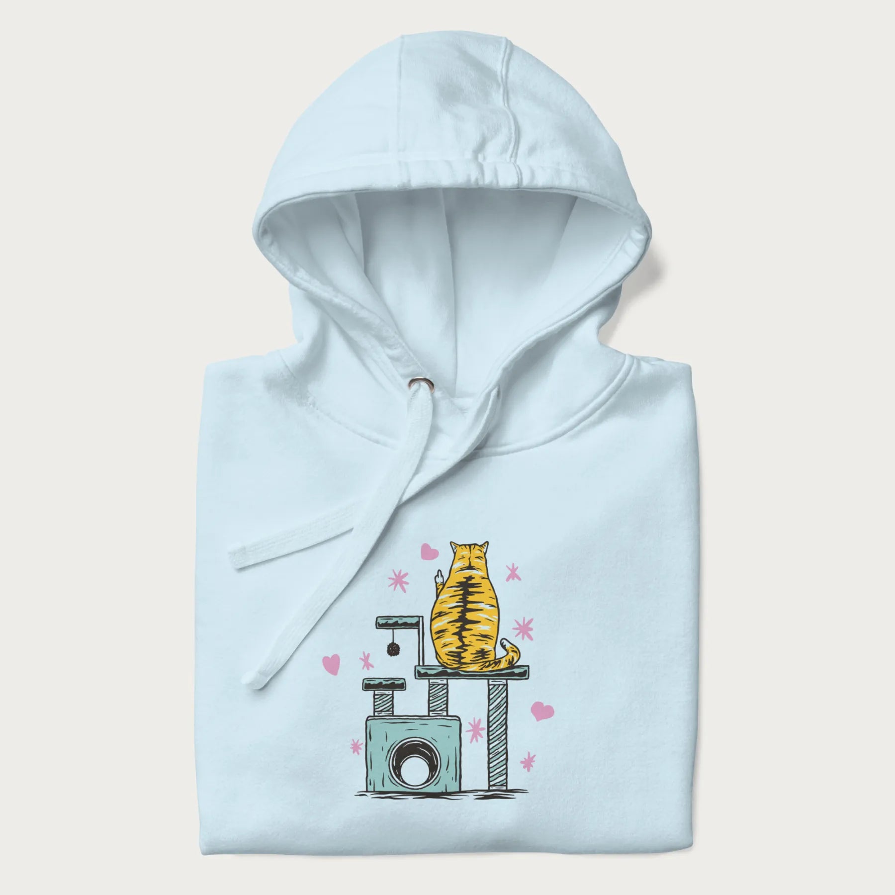 Folded light blue hoodie with graphic of a tabby cat on a scratching post, raising its middle finger.