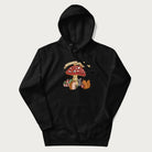 Black hoodie with animal around a festively decorated mushroom and the text 'Christmas with the Beloved' above.