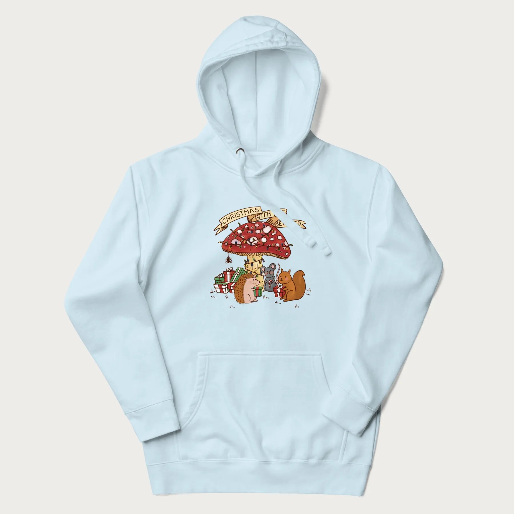 Light blue hoodie with animal around a festively decorated mushroom and the text 'Christmas with the Beloved' above.