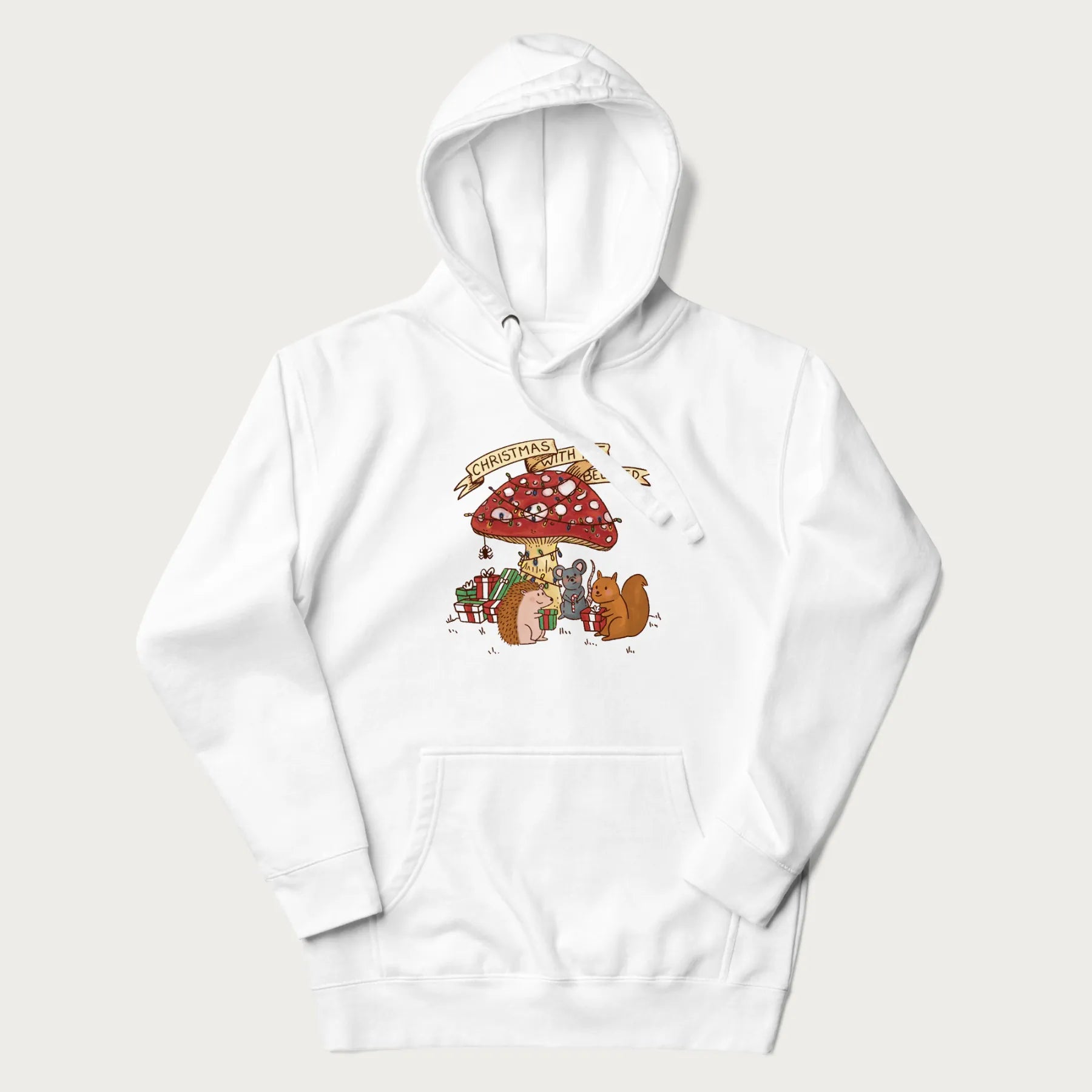 White hoodie with animal around a festively decorated mushroom and the text 'Christmas with the Beloved' above.