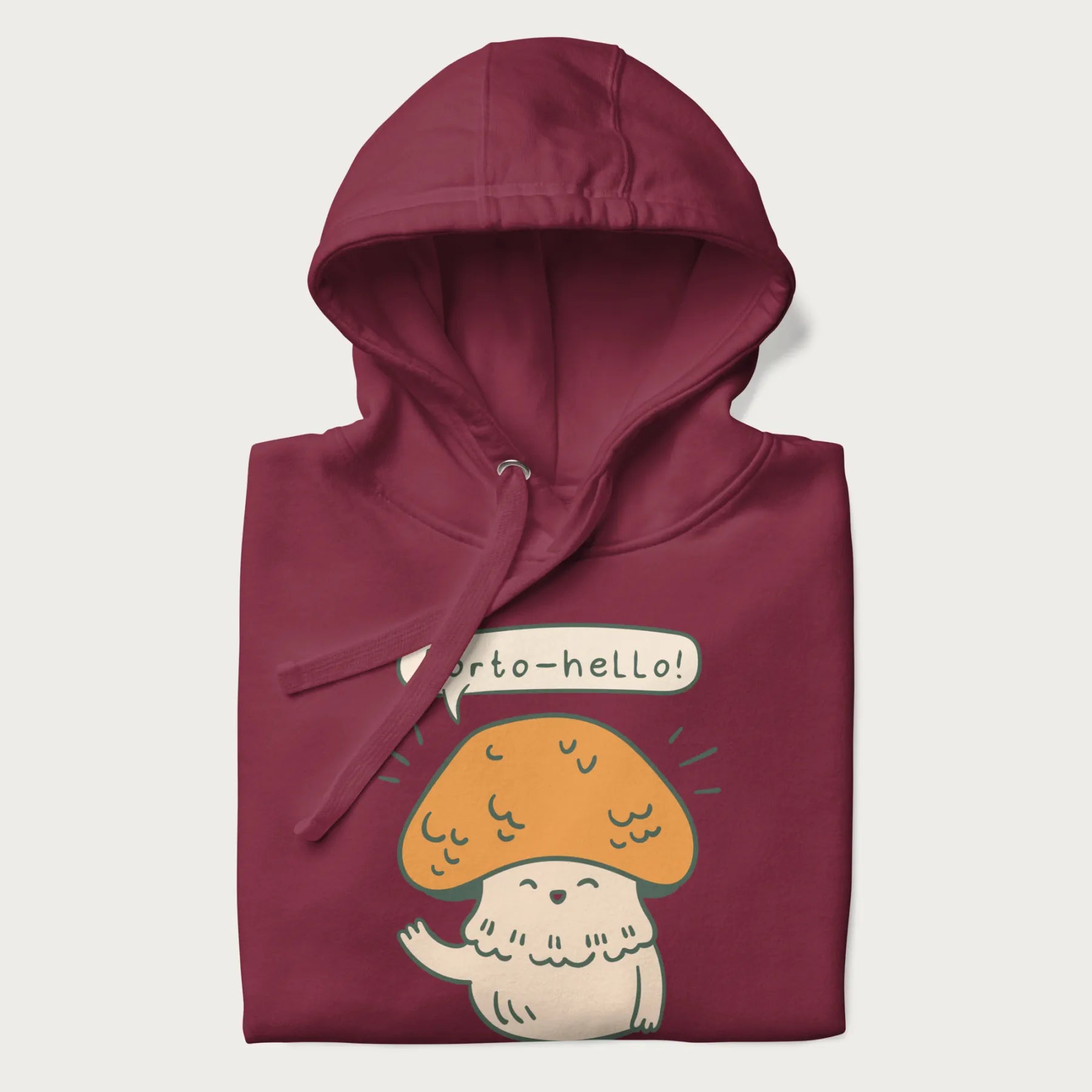 Folded maroon hoodie with a graphic of a cheerful mushroom character and the text 'Porto-hello!'.