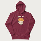 Maroon hoodie with a graphic of a cheerful mushroom character and the text 'Porto-hello!'.