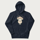 Navy blue hoodie with a graphic of an adorable mushroom character and the text 'Shiitake Happens'.