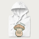 Folded white hoodie with a graphic of an adorable mushroom character and the text 'Shiitake Happens'.