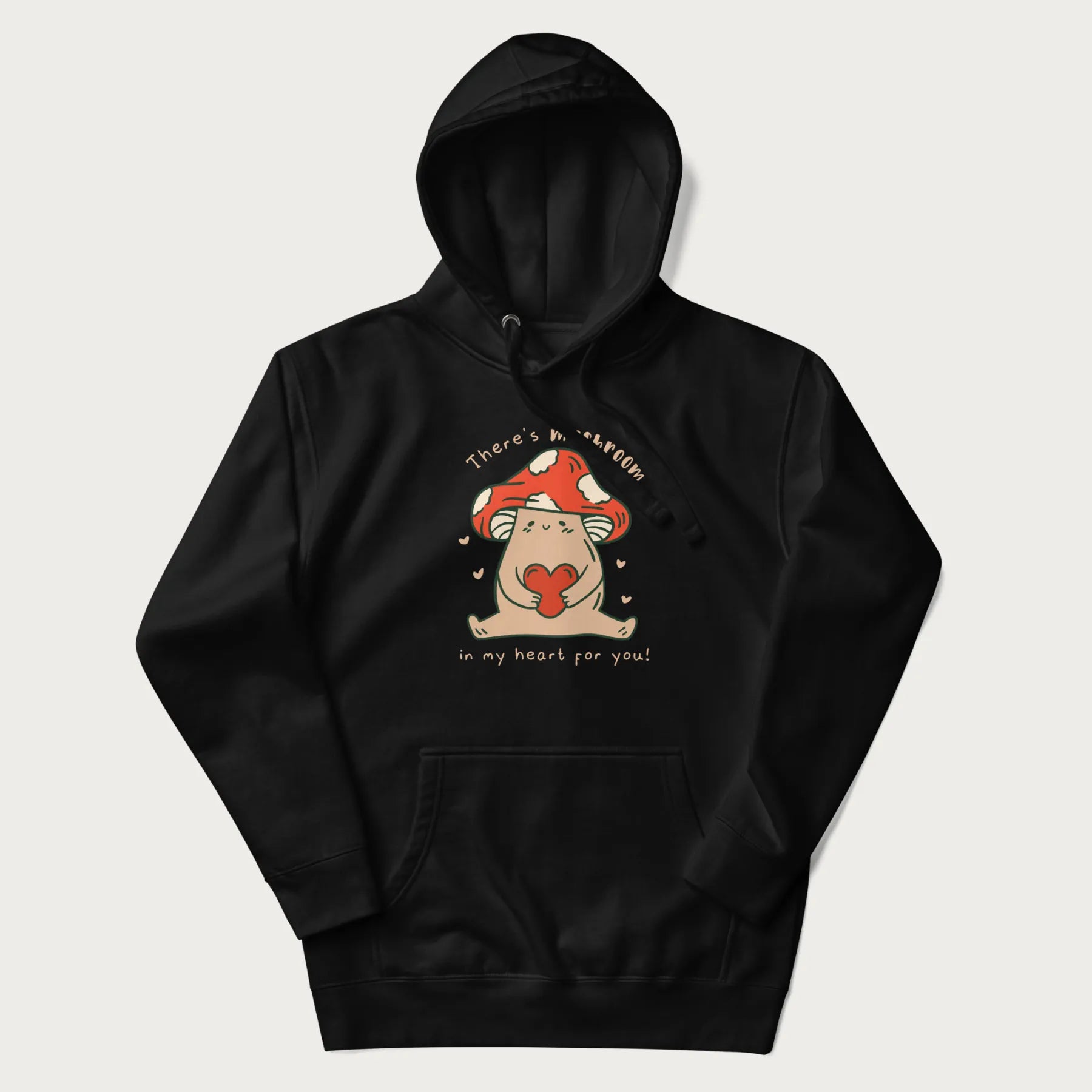 Folded black hoodie with a graphic of a mushroom character holding a heart and the text 'There's Mushroom in My Heart for You'.