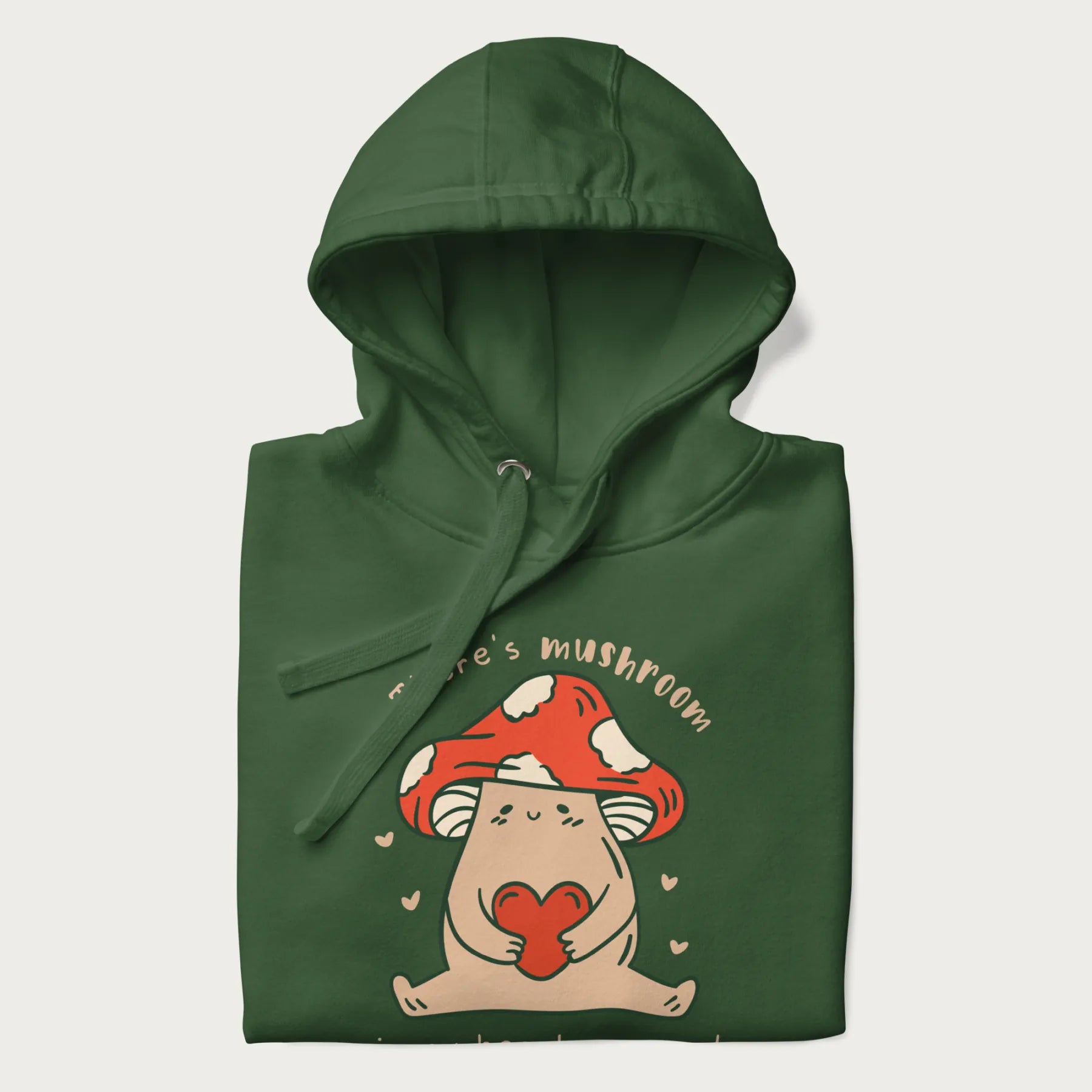 Folded forest green hoodie with a graphic of a mushroom character holding a heart and the text 'There's Mushroom in My Heart for You'.