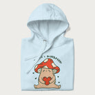 Folded light blue hoodie with a graphic of a mushroom character holding a heart and the text 'There's Mushroom in My Heart for You'.