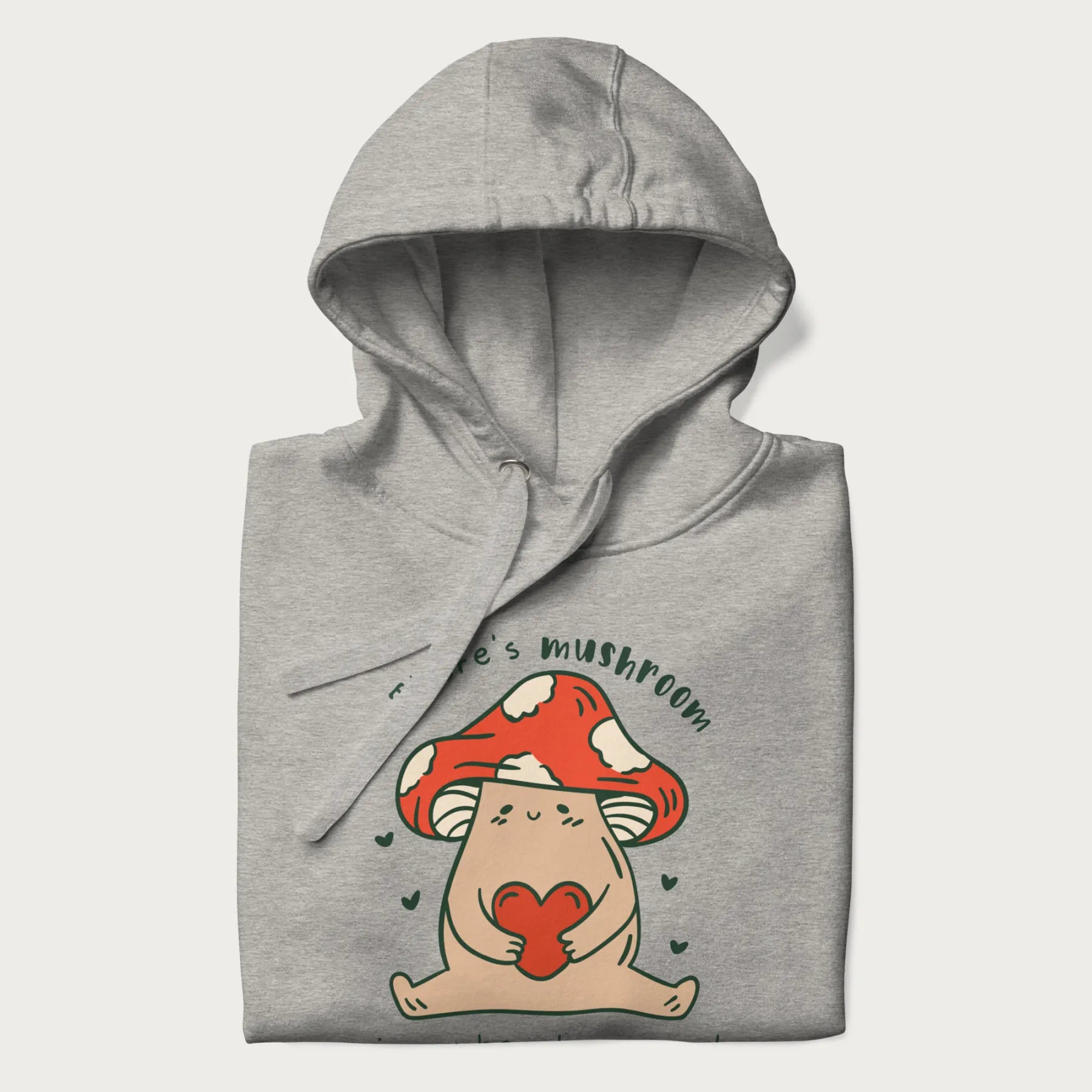 Folded light grey hoodie with a graphic of a mushroom character holding a heart and the text 'There's Mushroom in My Heart for You'.