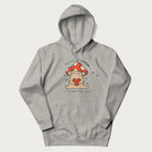 Light grey hoodie with a graphic of a mushroom character holding a heart and the text 'There's Mushroom in My Heart for You'.