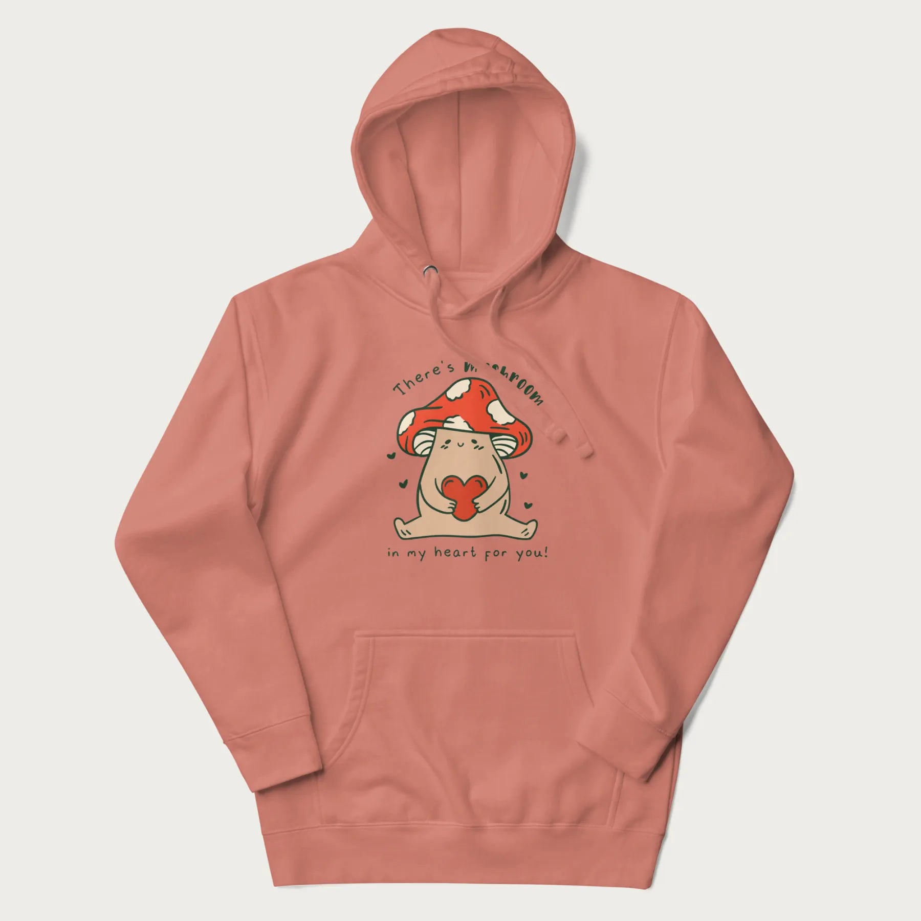 Light pink hoodie with a graphic of a mushroom character holding a heart and the text 'There's Mushroom in My Heart for You'.