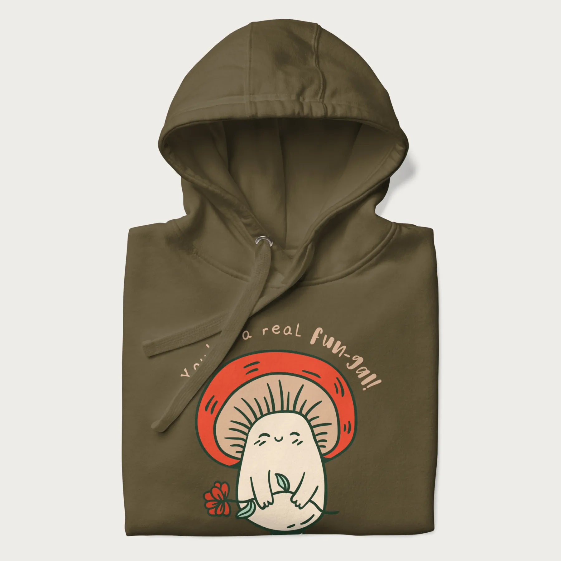 Folded military green hoodie with a graphic of a cute mushroom character holding a flower and the text 'You're a real fun-gal!'.