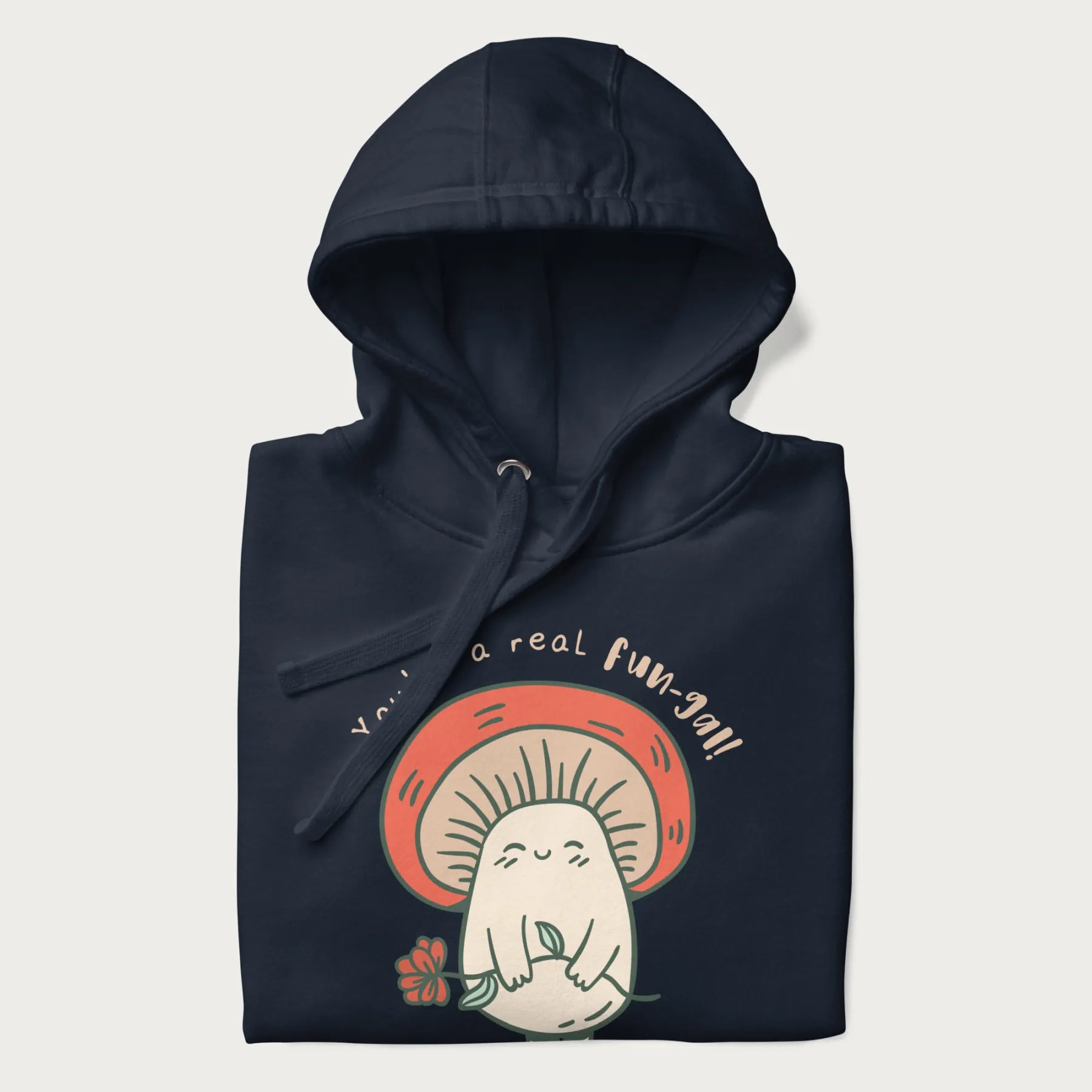 Folded navy blue hoodie with a graphic of a cute mushroom character holding a flower and the text 'You're a real fun-gal!'.