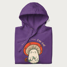 Folded purple hoodie with a graphic of a cute mushroom character holding a flower and the text 'You're a real fun-gal!'.