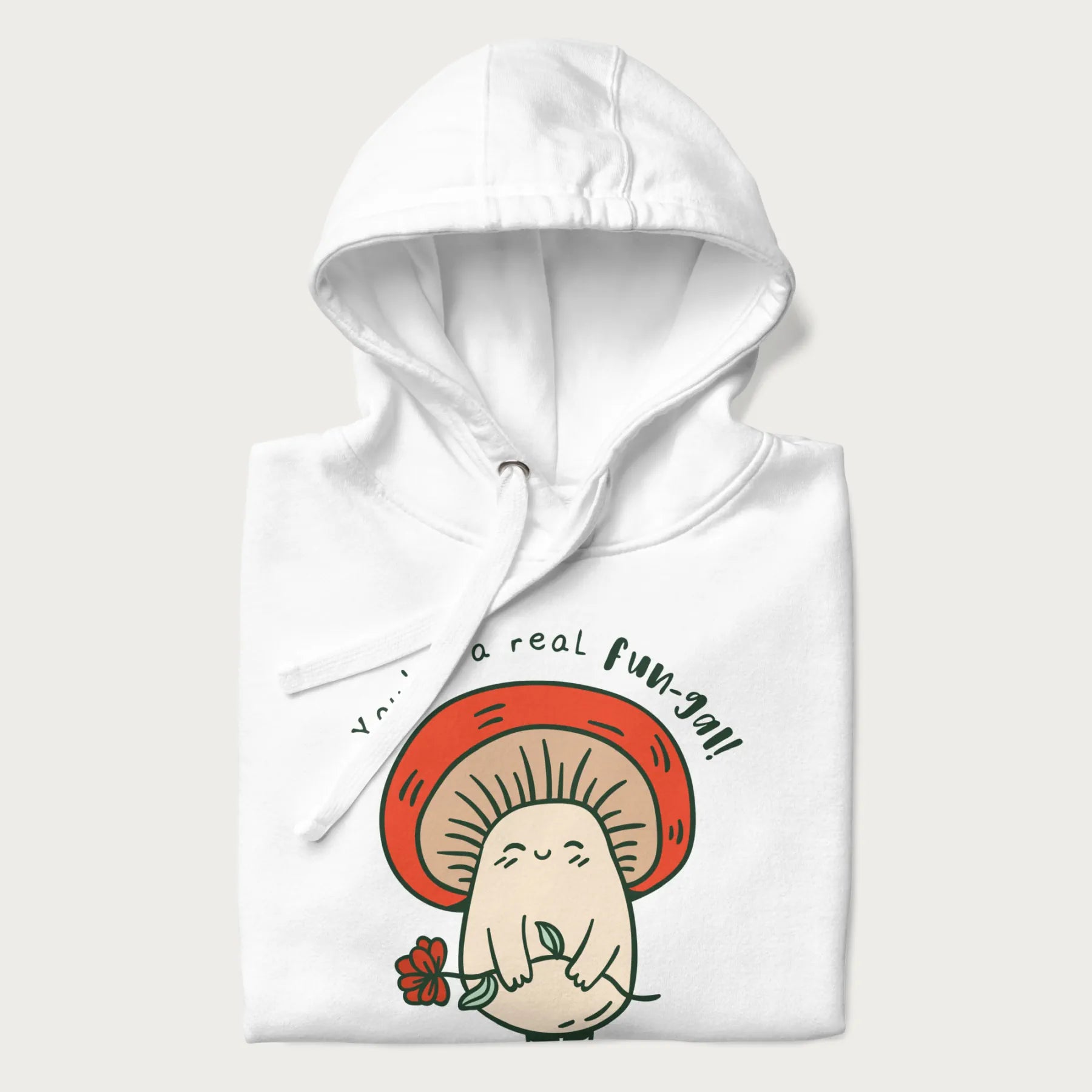 Folded white hoodie with a graphic of a cute mushroom character holding a flower and the text 'You're a real fun-gal!'.