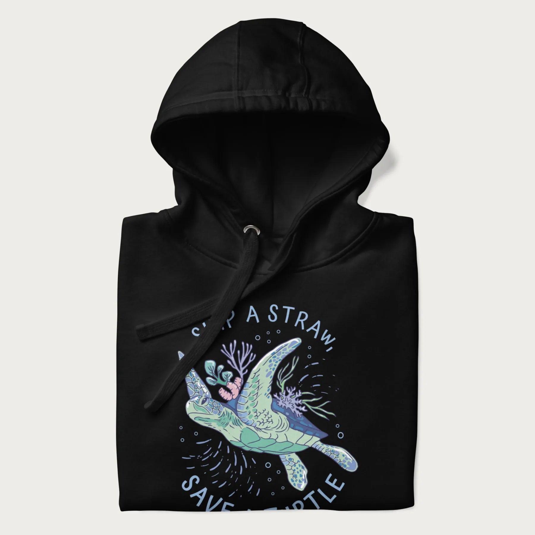 Folded black hoodie with a graphic of a sea turtle with coral on it's shell and the text 'Skip a Straw, Save a Turtle'.