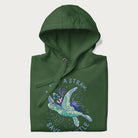 Folded forest green hoodie with a graphic of a sea turtle with coral on it's shell and the text 'Skip a Straw, Save a Turtle'.