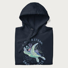 Folded navy blue hoodie with a graphic of a sea turtle with coral on it's shell and the text 'Skip a Straw, Save a Turtle'.