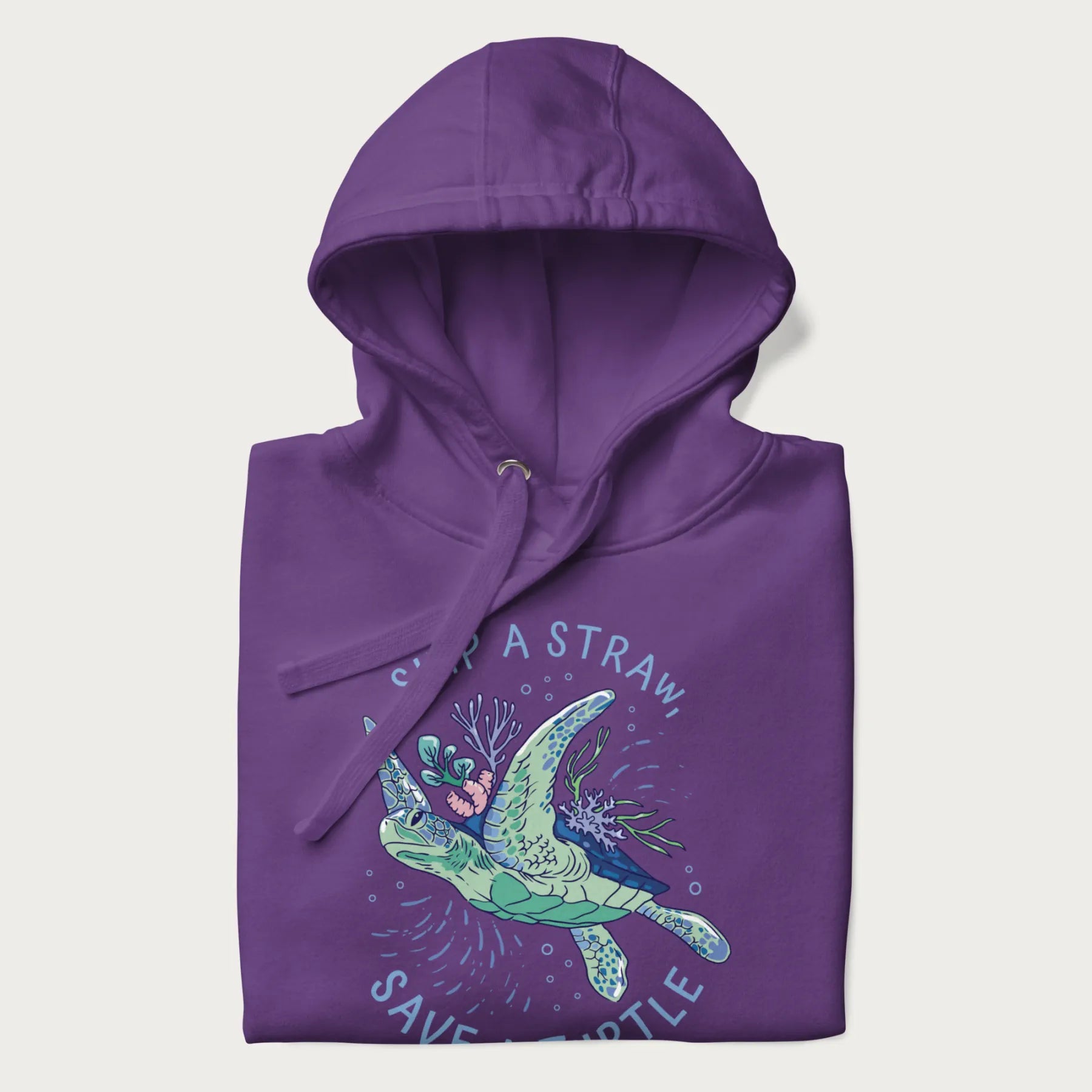 Folded purple hoodie with a graphic of a sea turtle with coral on it's shell and the text 'Skip a Straw, Save a Turtle'.