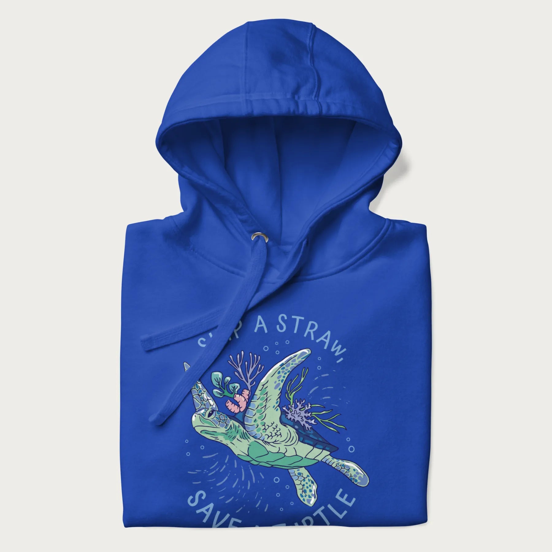 Folded royal blue hoodie with a graphic of a sea turtle with coral on it's shell and the text 'Skip a Straw, Save a Turtle'.