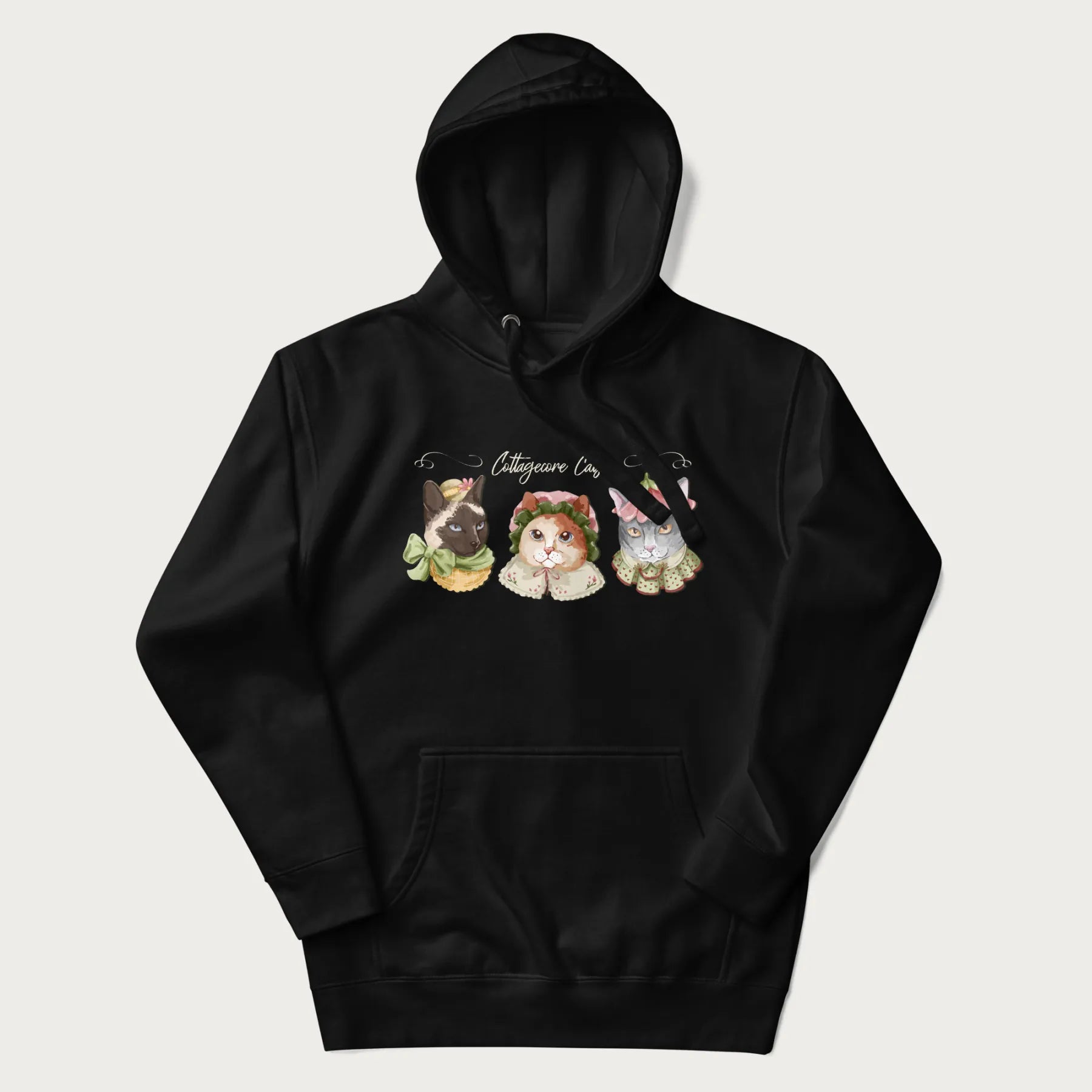 Black hoodie with a graphic of three cats in vintage-inspired attire and the text 'Cottagecore Cats'.