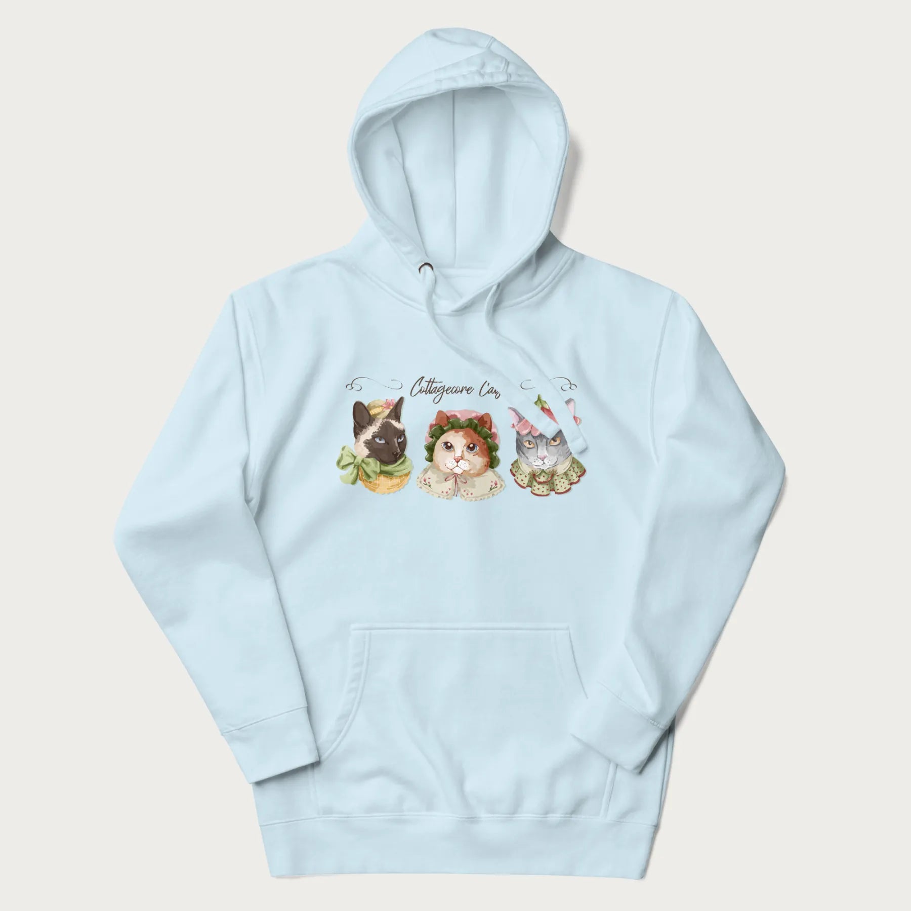 Light blue hoodie with a graphic of three cats in vintage-inspired attire and the text 'Cottagecore Cats'.