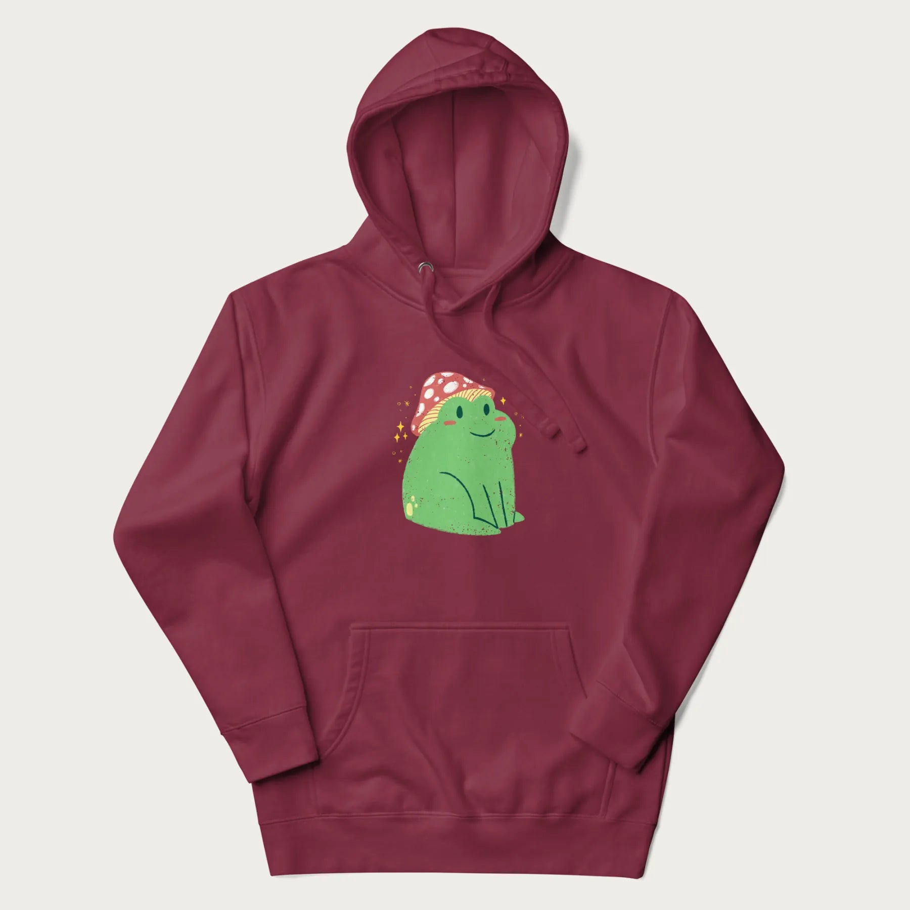 Maroon hoodie with a graphic of a green frog wearing a mushroom cap surrounded by stars.