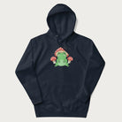 Navy blue hoodie will illustration of a cute green frog with red and white mushrooms.