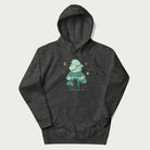 Dark grey hoodie with graphic of a frog playing a banjo on a mushroom with stars and a crescent moon.