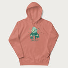 Light pink hoodie with graphic of a frog playing a banjo on a mushroom with stars and a crescent moon.