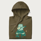 Folded military green hoodie with graphic of a frog playing a banjo on a mushroom with stars and a crescent moon.