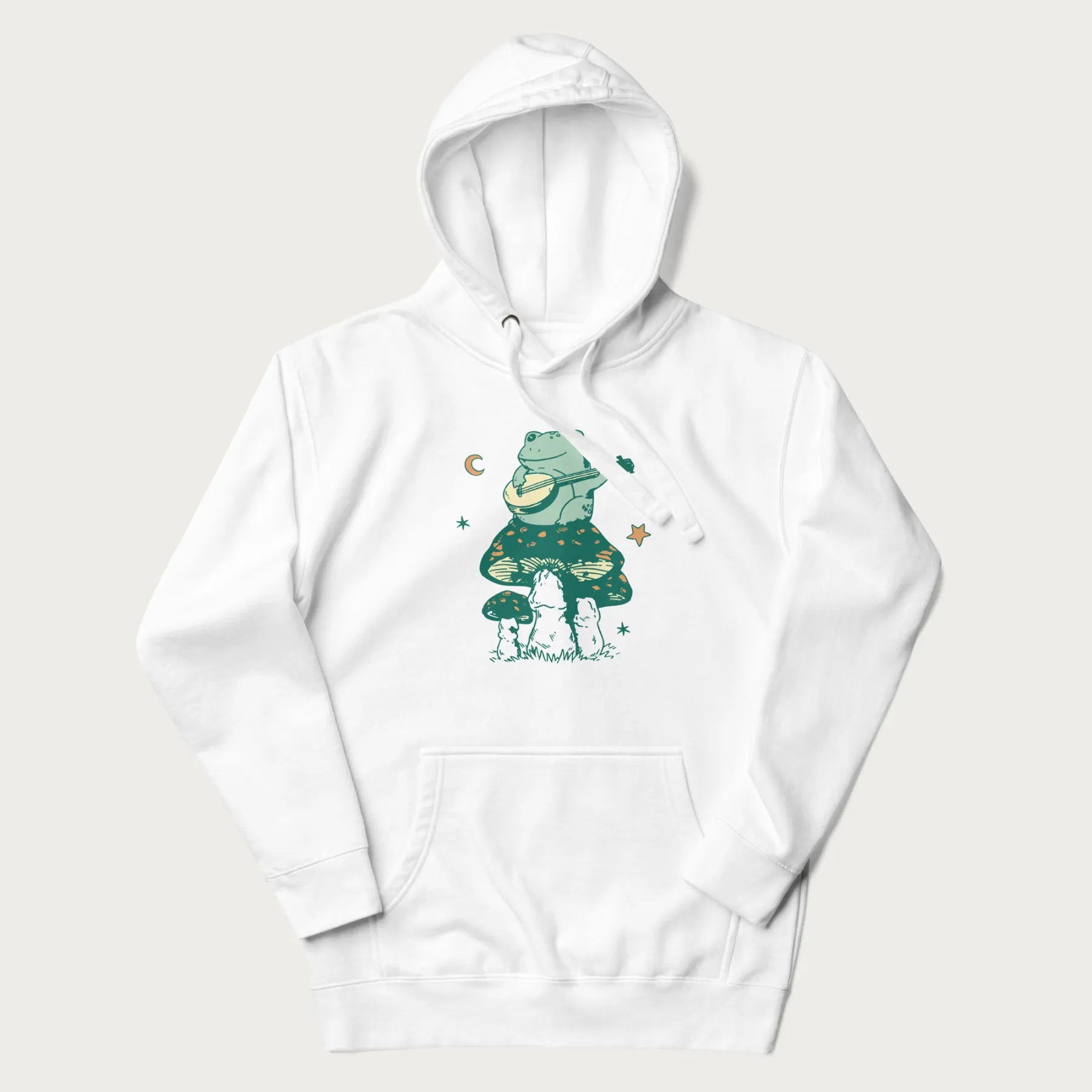 White hoodie with graphic of a frog playing a banjo on a mushroom with stars and a crescent moon.