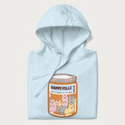 Cartoon cats in a pill bottle labeled 'Happy Pills' on a folded light blue hoodie.