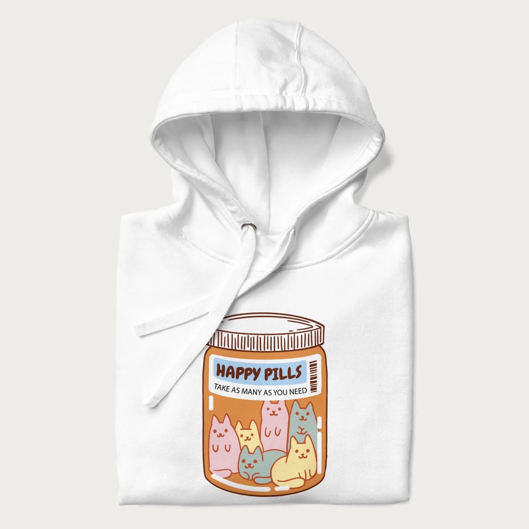 Cartoon cats in a pill bottle labeled 'Happy Pills' on a folded white hoodie.