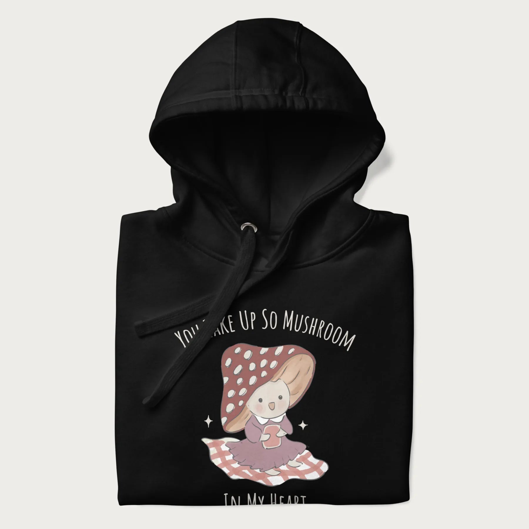 Folded black hoodie with a cute mushroom character and the text 'You Take Up So Mushroom in My Heart'.