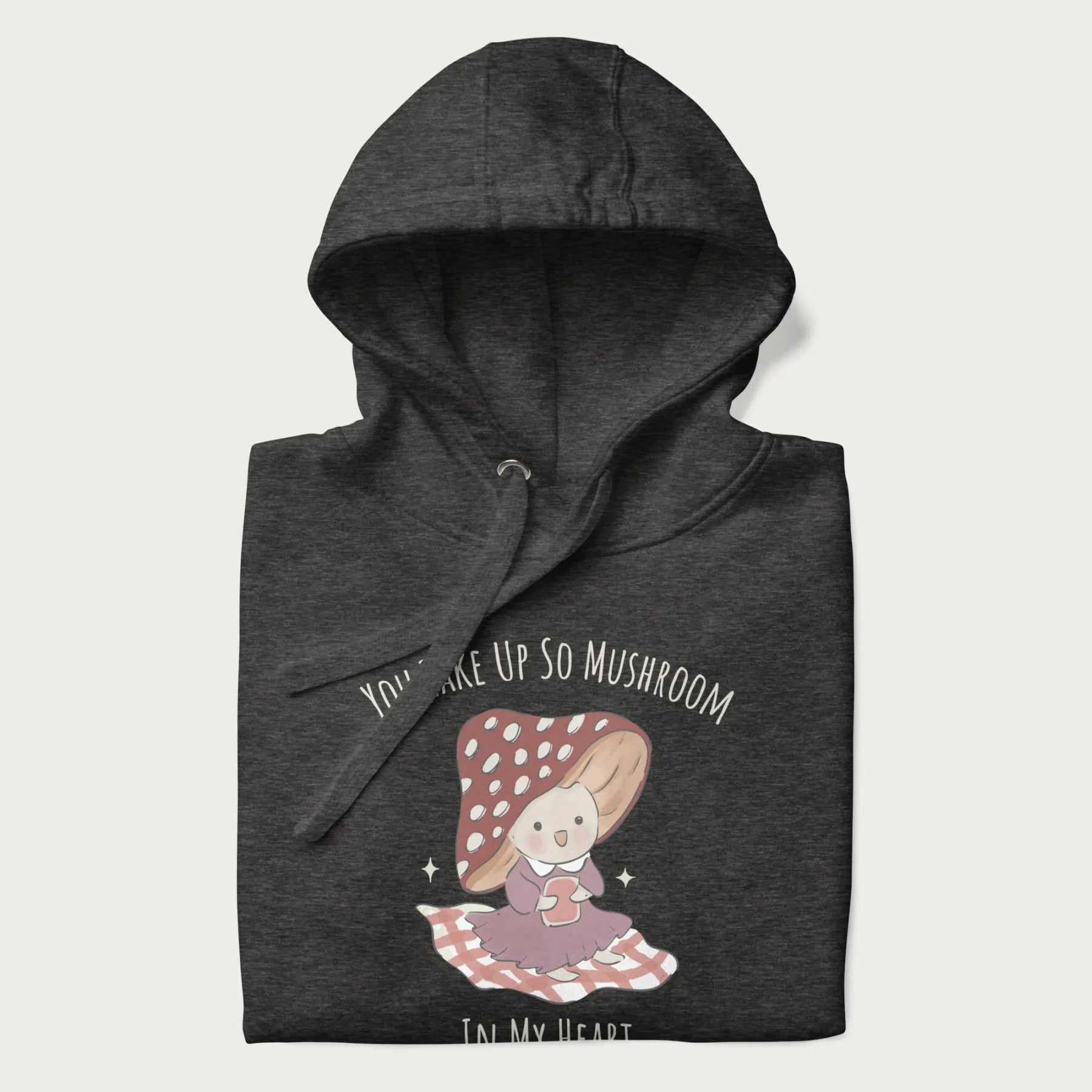 Folded dark grey hoodie with a cute mushroom character and the text 'You Take Up So Mushroom in My Heart'.
