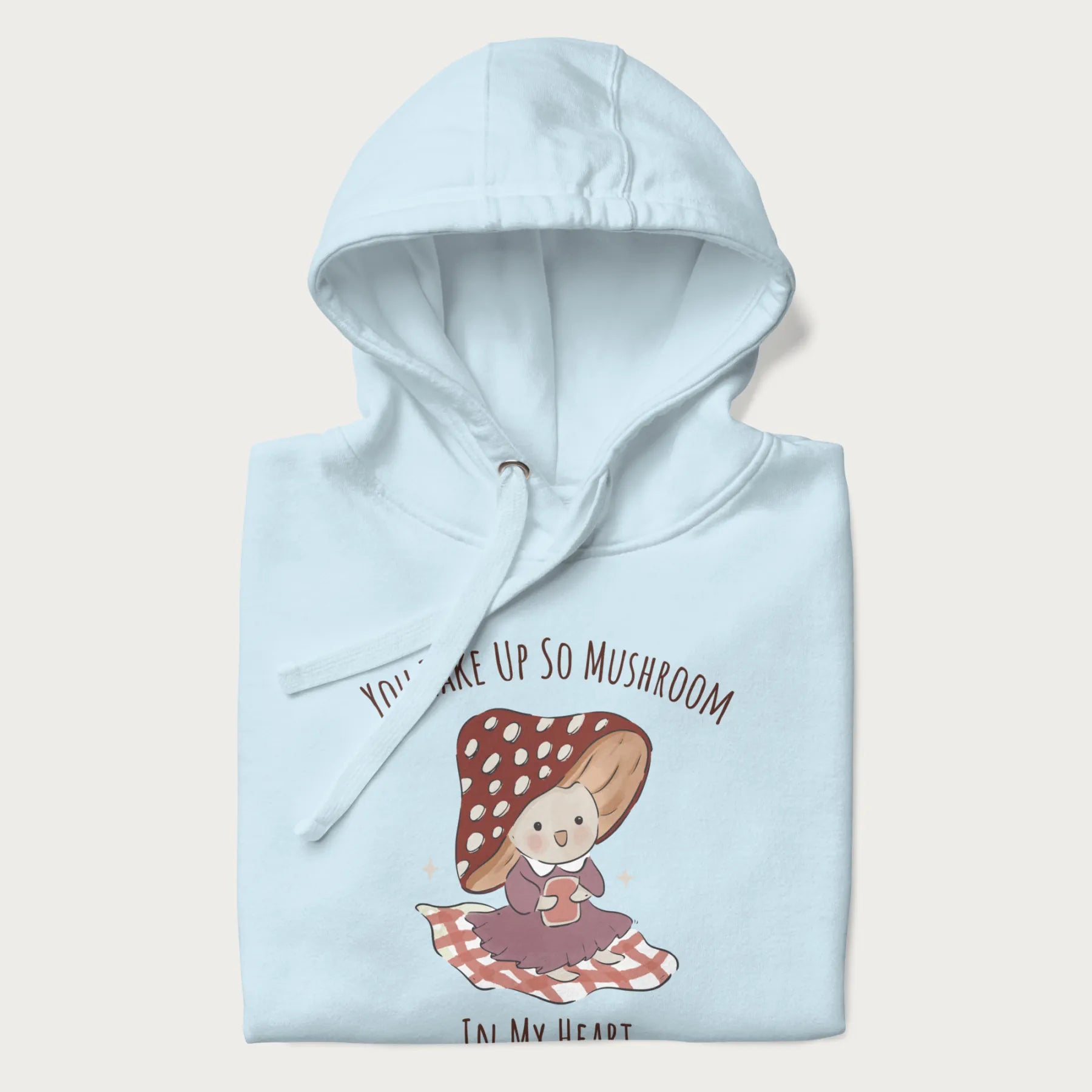 Folded light blue hoodie with a cute mushroom character and the text 'You Take Up So Mushroom in My Heart'.