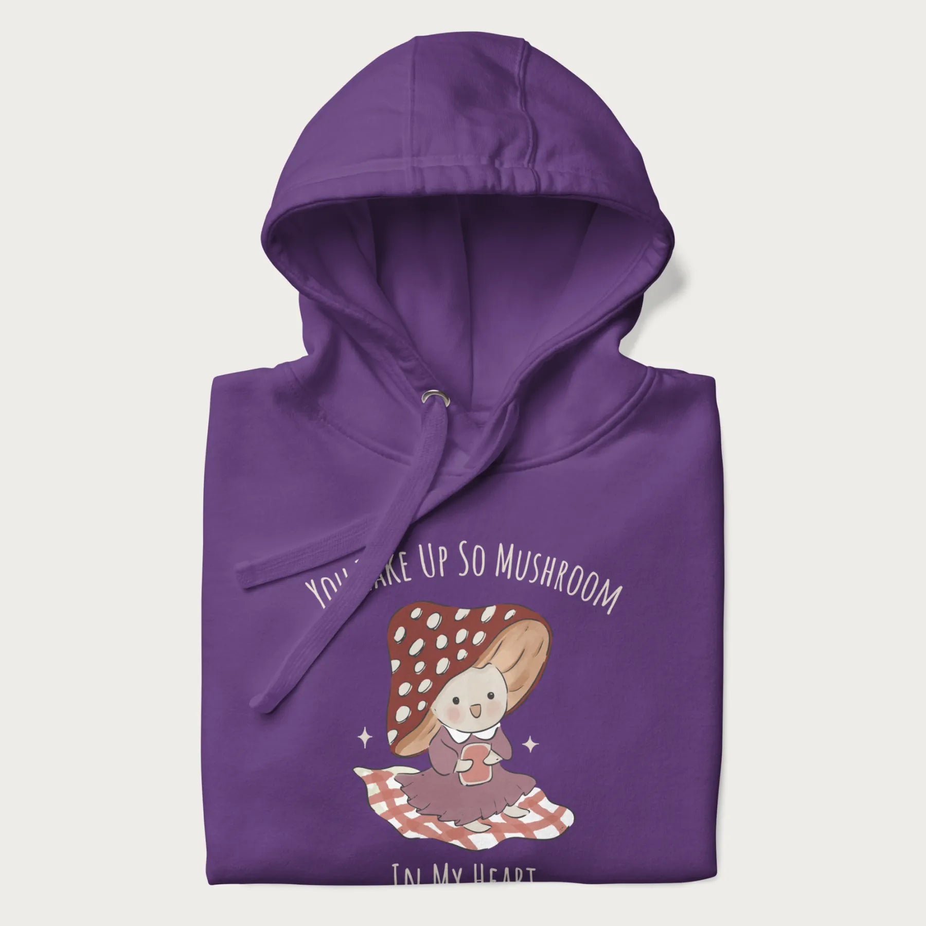 Folded purple hoodie with a cute mushroom character and the text 'You Take Up So Mushroom in My Heart'.