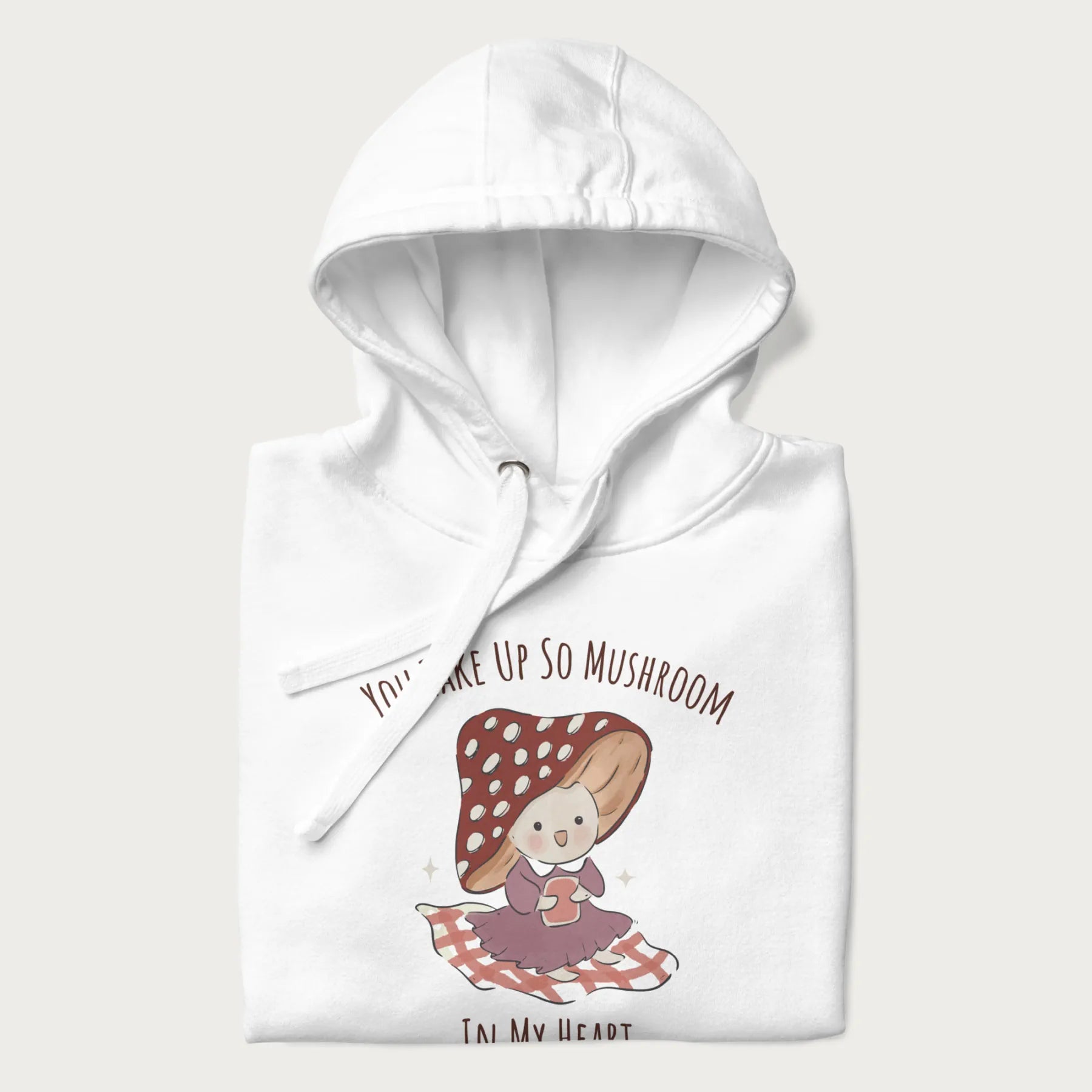 Folded white hoodie with a cute mushroom character and the text 'You Take Up So Mushroom in My Heart'.