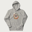 Light grey hoodie with graphic of an adorable raccoon surrounded by mushrooms, foliage, and a crescent moon with stars in the background.