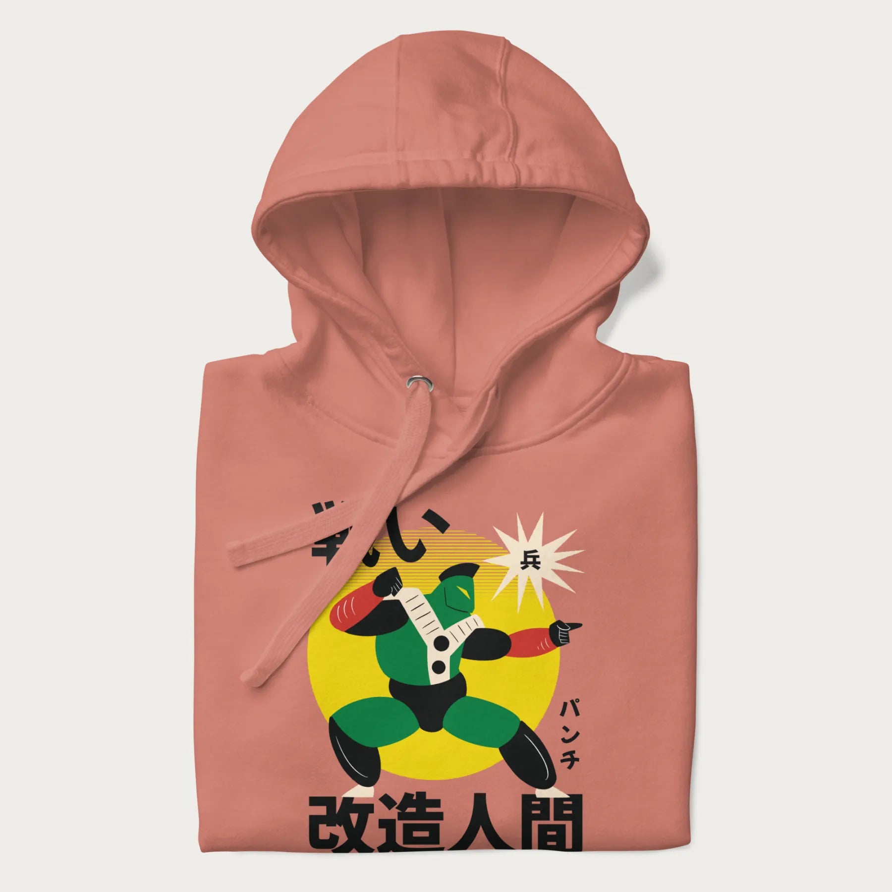 Folded light pink hoodie with Japanese text and retro graphic of a cyborg.