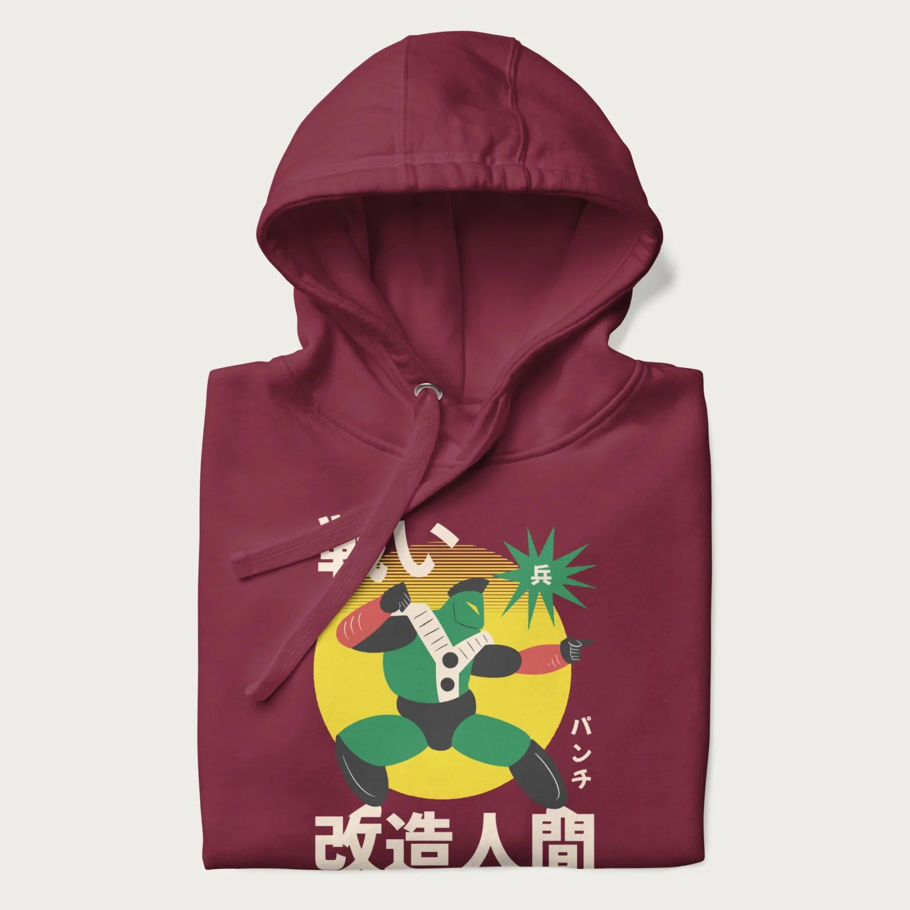 Folded maroon hoodie with Japanese text and retro graphic of a cyborg.