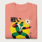 Folded light pink sweatshirt with Japanese text and a retro-styled robot graphic.