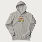 Light grey hoodie with a graphic of a frog lounging under mushrooms and the phrases 'Don't Be Stressin' Life's a Blessing'.