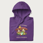 Folded purple hoodie with a graphic of a frog lounging under mushrooms and the phrases 'Don't Be Stressin' Life's a Blessing'.