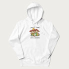 White hoodie with a graphic of a frog lounging under mushrooms and the phrases 'Don't Be Stressin' Life's a Blessing'.