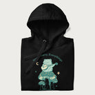 Folded black hoodie with a graphic of a frog playing a banjo on a mushroom under the moon and stars, with the text 'Don't Worry, Everything's Gonna Be Just Fine.'