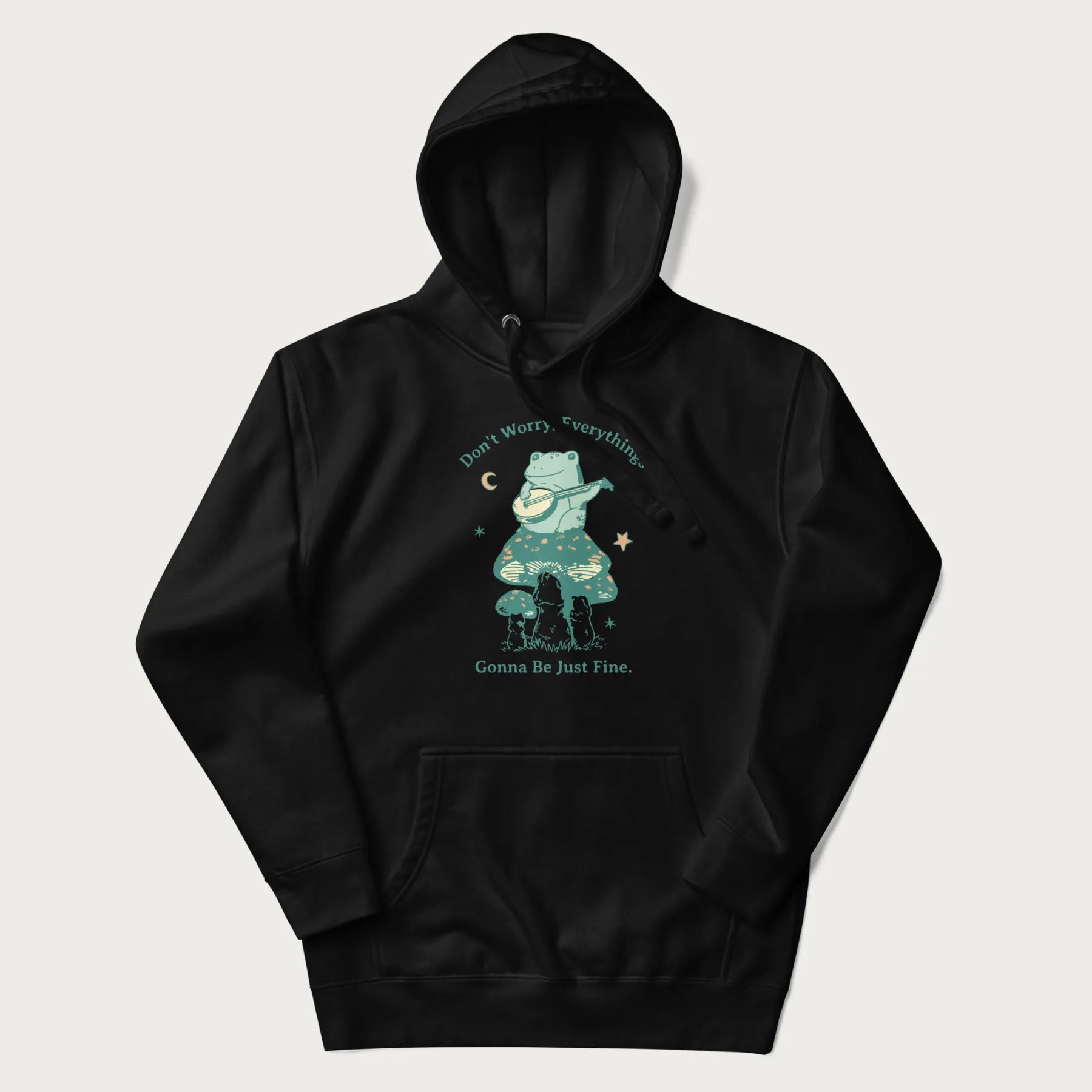 Black hoodie with a graphic of a frog playing a banjo on a mushroom under the moon and stars, with the text 'Don't Worry, Everything's Gonna Be Just Fine.'