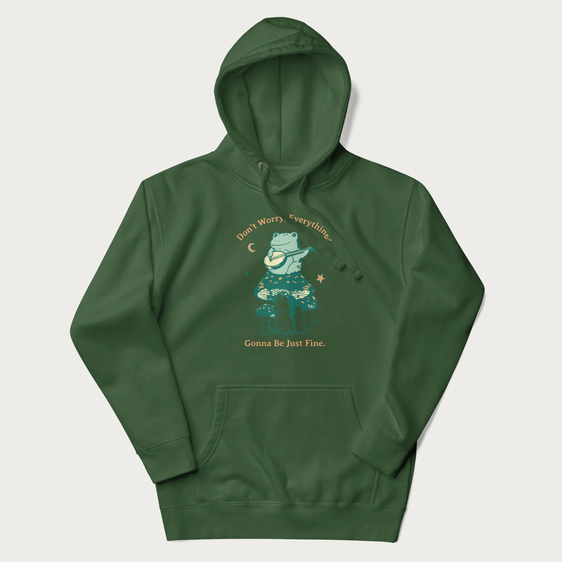 Forest green hoodie with a graphic of a frog playing a banjo on a mushroom under the moon and stars, with the text 'Don't Worry, Everything's Gonna Be Just Fine.'