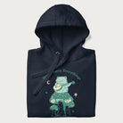 Folded navy blue hoodie with a graphic of a frog playing a banjo on a mushroom under the moon and stars, with the text 'Don't Worry, Everything's Gonna Be Just Fine.'